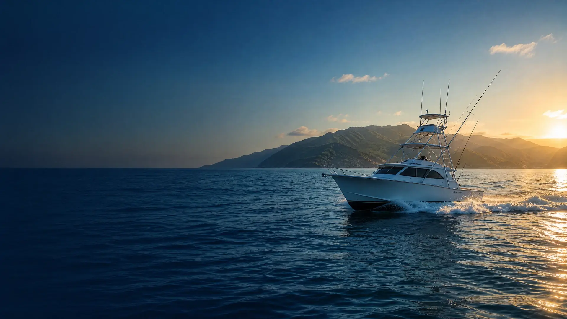 A sportfishing boat running along the Puerto Vallarta coastline at sunset, with the Sierra Madre mountains behind it